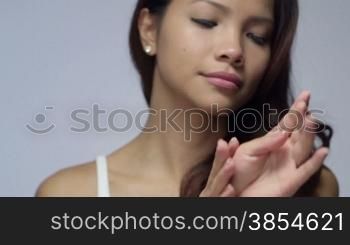 Young people, female teen, woman, cosmetics, beauty and body care, portrait of happy Asian girl smiling, applying lotion for hand skin treatment. 2of16