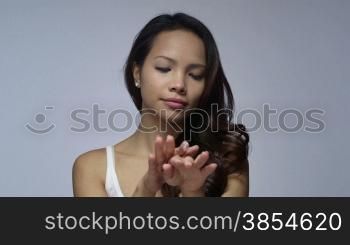 Young people, female teenager, woman, cosmetics, beauty and body care, portrait of happy Asian girl smiling, applying moisturizer for hand skin therapy. 1of16