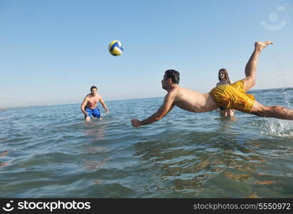 young people group have fun and play beach volleyball at sunny summer day