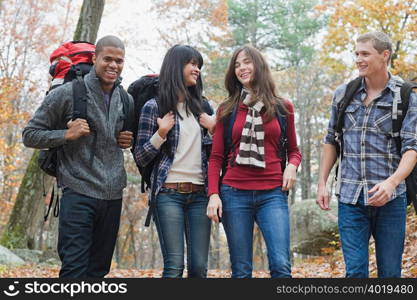 Young people hiking through forest