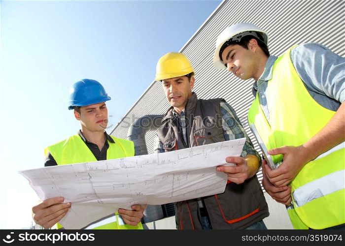 Young people in professional training on industrial site