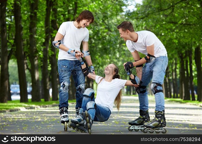 Young people lift the fallen girl on rollers