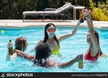 young people of different ethnicities drinking party beer in a swimming pool