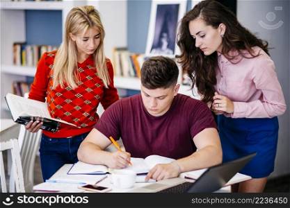 young people preparing assignment