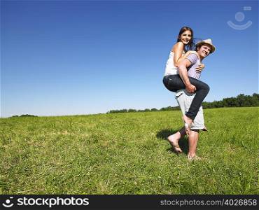young people riding piggy back