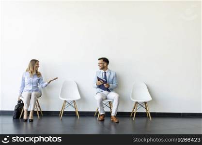 Young people sitting at chairs in the waiting room before an interview