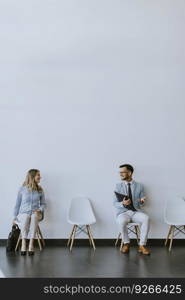 Young people sitting at chairs in the waiting room before an interview