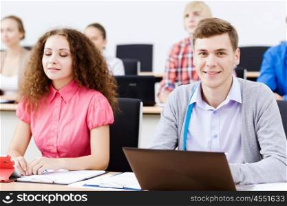 Young people sitting in classroom at lecture. Students at lesson