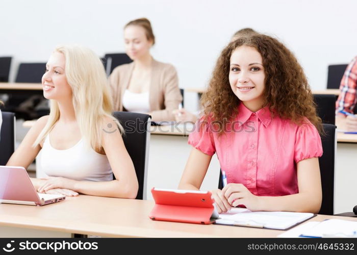 Young people sitting in classroom at lecture. Students at lesson