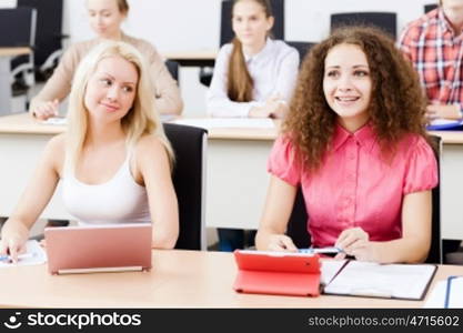 Young people sitting in classroom at lecture. Students at lesson