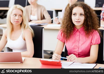 Young people sitting in classroom at lecture. Students at lesson