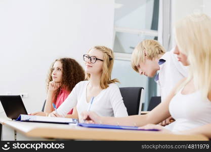 Young people sitting in classroom at lecture. Students at lesson