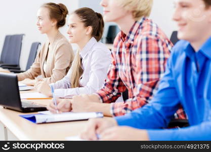 Young people sitting in classroom at lecture. Students at lesson