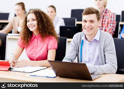 Young people sitting in classroom at lecture. Students at lesson