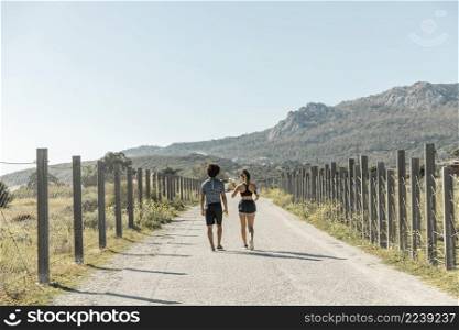 young people sportswear walking along country road
