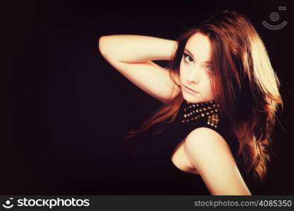 Young people teenage concept - pensive serious woman portrait, fashion teenager girl wearing blouse with gold metal stud on black