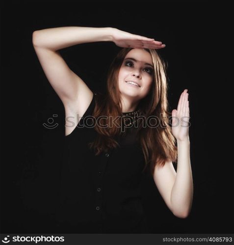 Young people teenage concept - teen funny girl making silly face making spectacles on black