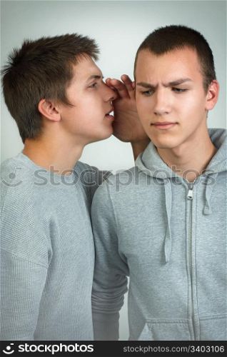 Young people telling secret to his friend