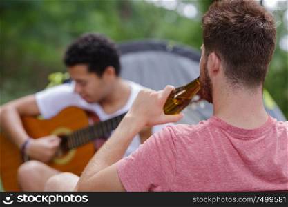 young people tent guitar and beer