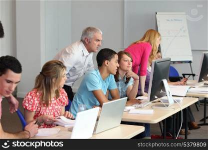 Young people using computers in class
