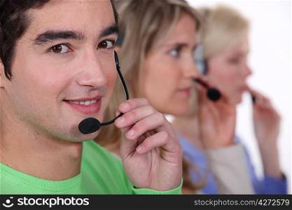 Young people with telephone headsets