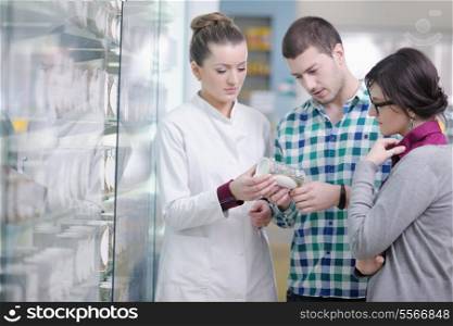 young pharmacist suggesting medical drug to buyer in pharmacy drugstore