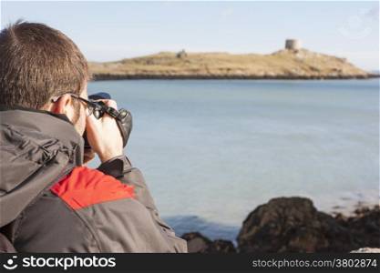 Young photographer in the coast