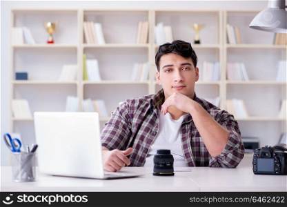Young photographer sitting at the desk