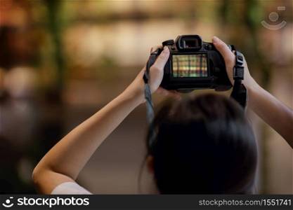 Young Photographer Woman Raise Up a Camera to Taking Photo. Selective Focus on Camera