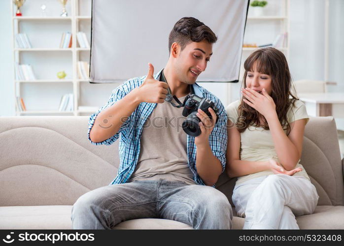 Young photographer working in photo studio