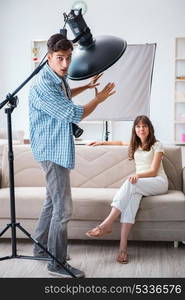 Young photographer working in photo studio