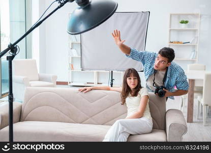 Young photographer working in photo studio