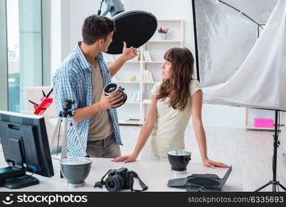 Young photographer working in photo studio