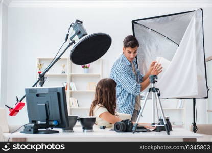 Young photographer working in photo studio