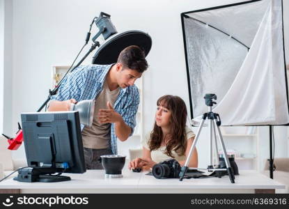 Young photographer working in photo studio