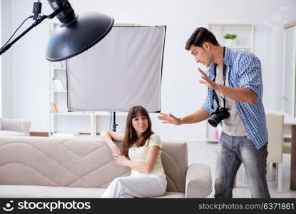 Young photographer working in photo studio