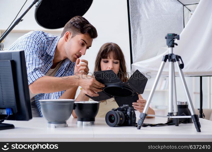 Young photographer working in photo studio