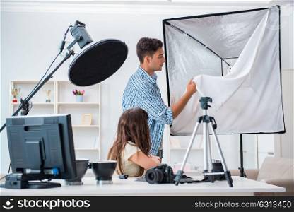 Young photographer working in photo studio. The young photographer working in photo studio