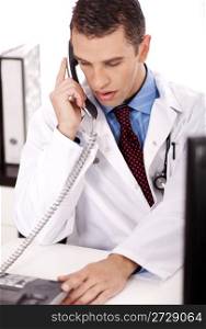 young physician sitting at his desk talking over phone in white background