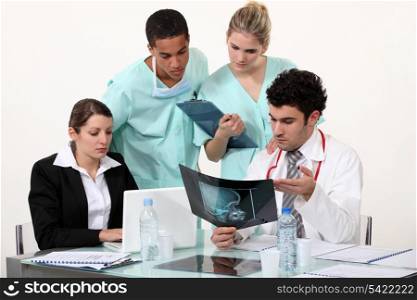 young physician surrounded by male and female nurse