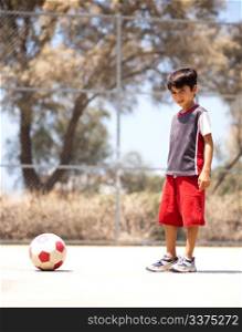 Young player ready to play soccer, outdoors
