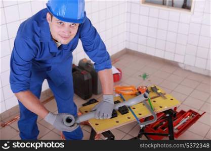 young plumber with miscellaneous tools