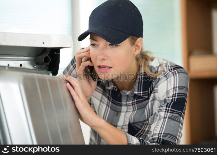 young plumber woman happy talking using a smartphone mobile phone