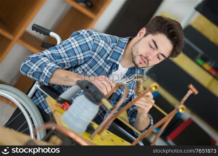 young plumber worker in a wheelchair