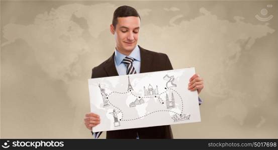 Young positive business man holding banner with world map and famous symbols. Business travel concept