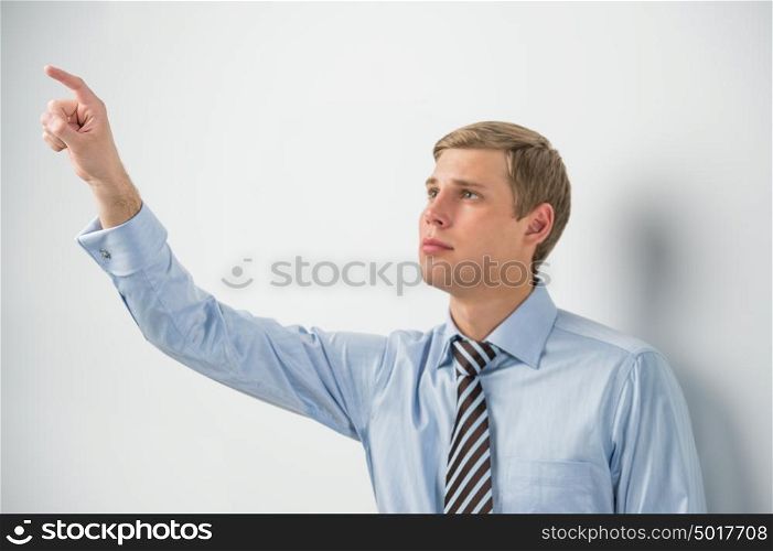 Young positive business man touching virtual button. Editable image