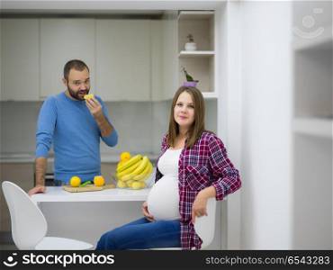 young pregnant couple cooking food fruit lemon juice at kitchen, lifestyle healthy pregnancy happy life concept. couple cooking food fruit lemon juice at kitchen