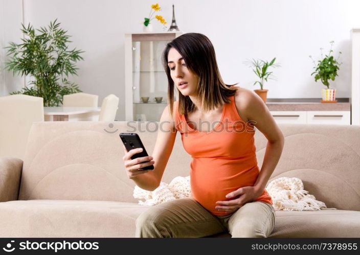 Young pregnant woman at home 