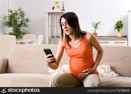 Young pregnant woman at home 