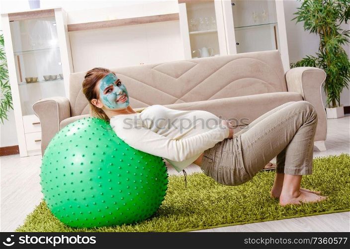 Young pregnant woman doing exercises at home 
